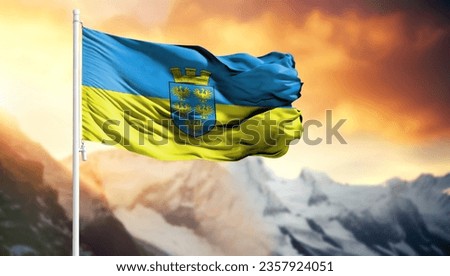 Flag of Lower Austria on a flagpole against a colorful sky