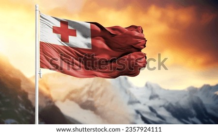 Flag of Tonga on a flagpole against a colorful sky