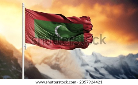 Flag of Maldives on a flagpole against a colorful sky