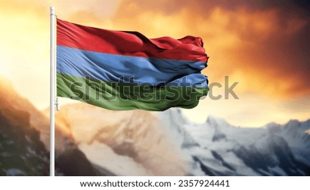 Flag of Karelia on a flagpole against a colorful sky