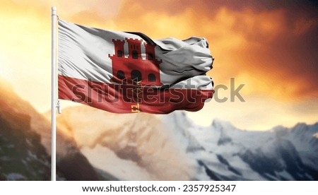 Flag of Gibraltar on a flagpole against a colorful sky