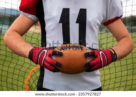 American football ball. American football on dark background. Team sport concept. copy space. space for text. American football background. America Soccer ball. Person holding American football.