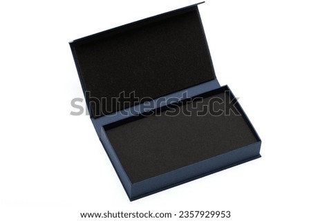 Dark blue open gift box with foam liner on white background. 