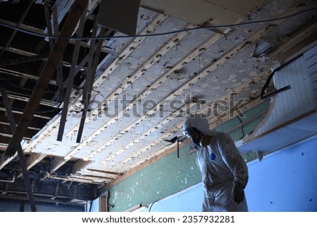 Demolition Worker in Respirator and Coveralls Royalty-Free Stock Photo #2357932281