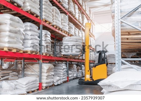 Forklift in a food warehouse loading goods on a rack Royalty-Free Stock Photo #2357939307