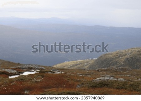 Rocky mountains in Scandinavia. Mountains in a ski town in the north of Sweden. On the mountain. View of the city from above. Lake on the horizon.