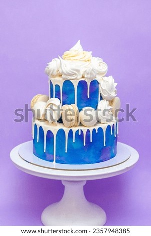 Layered blue cake on cake stand on a purple background. A picture for a menu or a catalog of confectionery products.