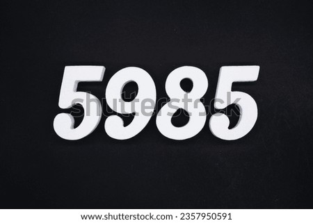 Black for the background. The number 5985 is made of white painted wood.