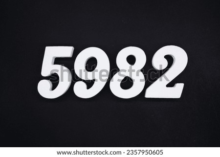 Black for the background. The number 5982 is made of white painted wood.