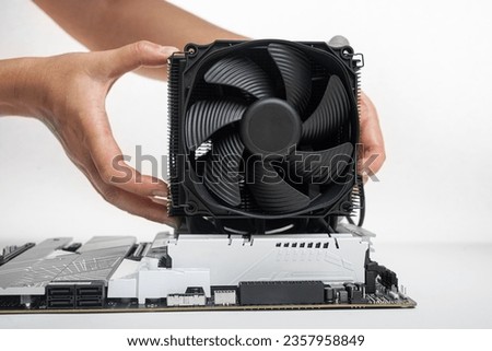 Installing a large air cooler on a computer processor. Royalty-Free Stock Photo #2357958849