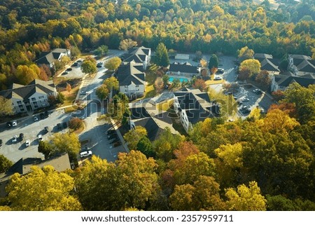View from above of apartment residential condos between yellow fall trees in suburban area in South Carolina. American homes as example of real estate development in US suburbs Royalty-Free Stock Photo #2357959711