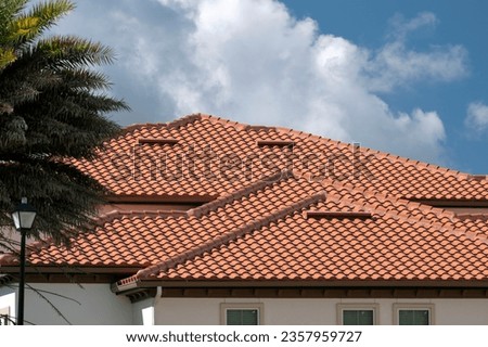 Tiled roof covering of condo building in Florida. Closeup of house rooftop covered with ceramic shingles Royalty-Free Stock Photo #2357959727