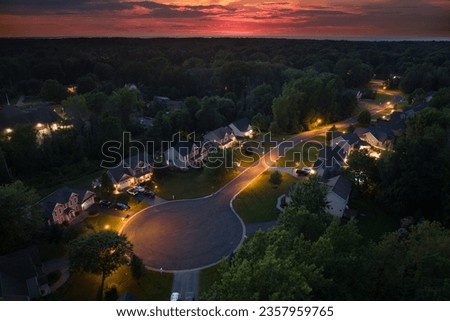 Low-density two story private homes at sunset. Rural street cul-de-sac dead end in residential suburbs with upscale suburban houses outside of Rochester, New York Royalty-Free Stock Photo #2357959765