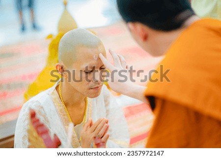 A monk about to apply talcum powder The forehead area of ​​the Naga is for the prosperity of the people according to the Thai tradition. Royalty-Free Stock Photo #2357972147