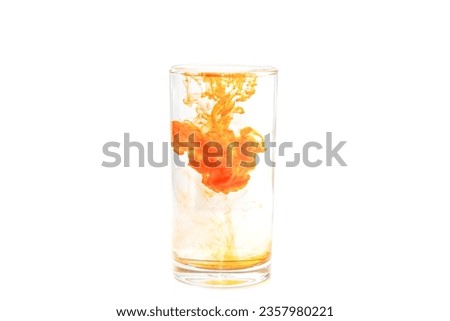 Orange ink dropping on glass water looks art and put on white background with isolated picture.