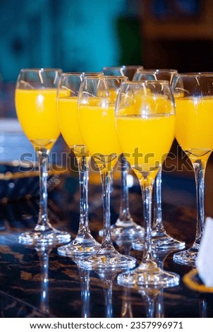 Alcoholic drink made with orange juice and champagne called Mimosa, a space for celebration and joy.