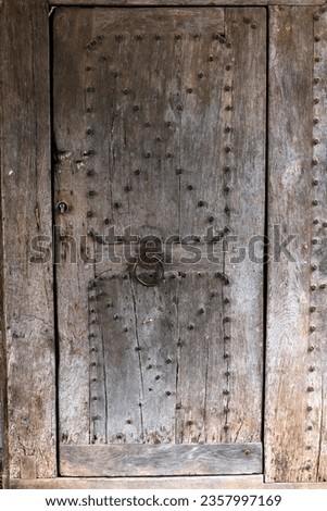 closeup of an old heavy wooden door.