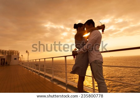 romantic couple hugging with eyes closed at sunset on a cruise ship Royalty-Free Stock Photo #235800778