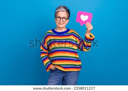 Photo of cheerful aged person toothy smile hand hold paper like notification card isolated on blue color background Royalty-Free Stock Photo #2358011217