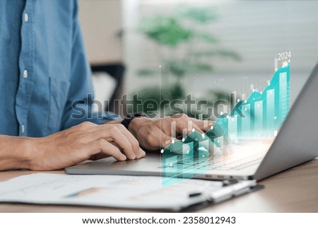 Businessman analyzes the company's profitability in 2024, credits its success. will grow up Businessman calculating financial data for long-term investments Royalty-Free Stock Photo #2358012943