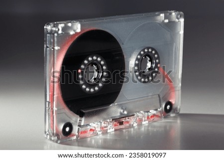 vintage analog audio cassette with transparent case and visible tape from the 80s