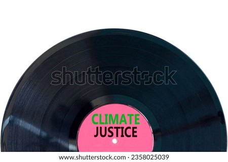 Climate justice symbol. Concept words Climate justice on beautiful black vinyl disk. Beautiful white table white background. Business environment climate justice concept. Copy space.