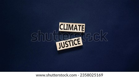 Climate justice symbol. Concept words Climate justice on beautiful wooden blocks. Beautiful black table black background. Business environment climate justice concept. Copy space.