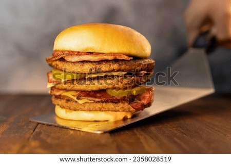triple cheese hamburger with bacon and pickles