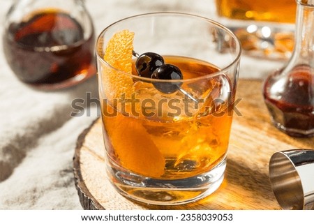 Boozy Maple Syrup Old Fashioned Cocktail with Bourbon and Cherries Royalty-Free Stock Photo #2358039053