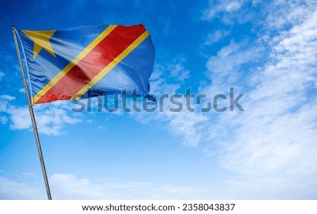 DR Congo Flag - Dynamic flag of the Democratic Republic of the Congo (DRC) waving energetically. This striking flag consists of a sky blue field, a red diagonal stripe, and a yellow five-pointed star,