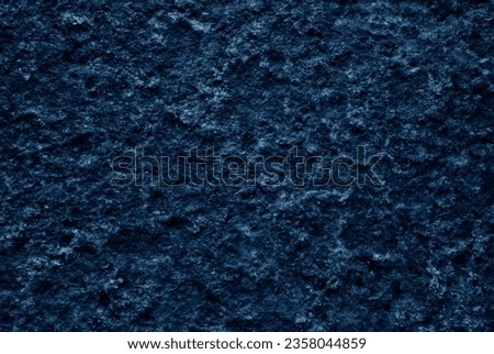 Dark blue texture, darkened background of a dark blue rock wall