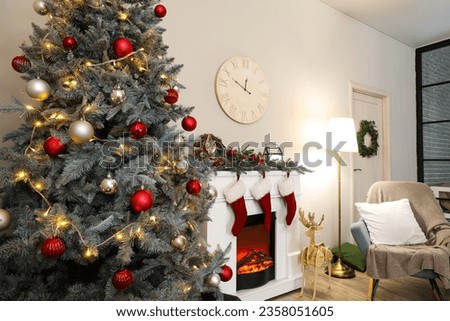 Interior of living room decorated for Christmas with fireplace and rocking chair