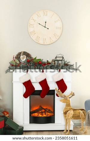 Interior of living room decorated for Christmas with fireplace and clock