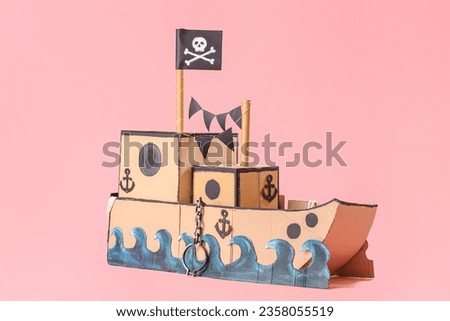 Pirate cardboard ship on pink background