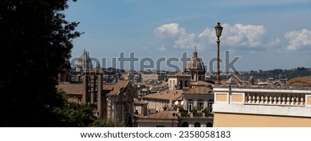 View of Rome from Piazza Caffarelli. St. Peter's Basilica, domes, churches, roofs and blue sky, banner image.