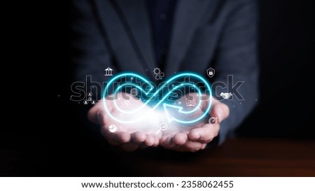 Infinity business success finance investment startup concept. Businessman holding virtual infinity with technology marketing online icons. Strategy planning banking internet computing technology.