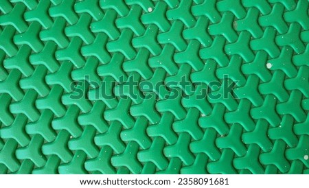 Plastic weave pattern background. Zigzag interlocking of symmetrical shapes. Green woven background.