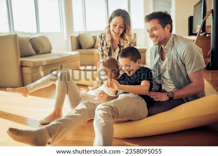 Young Caucasian family playing in the living room at home Royalty-Free Stock Photo #2358095055