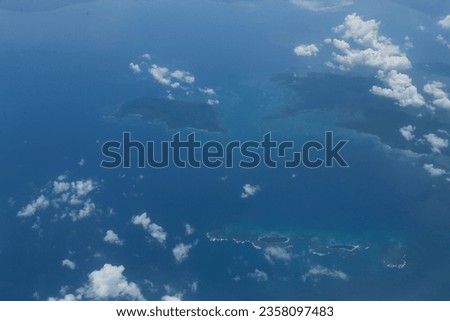 Aerial view of the land from the airplane with clouds