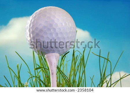 Golf ball shot from below on a tee