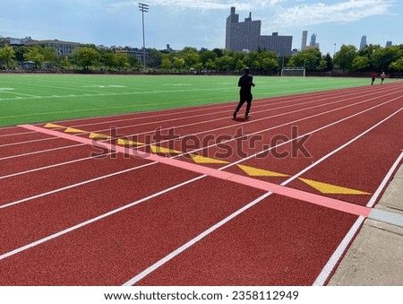 Man running on the track at Riverbank State Park on a sunny summer day in West Harlem, New York City, USA Royalty-Free Stock Photo #2358112949