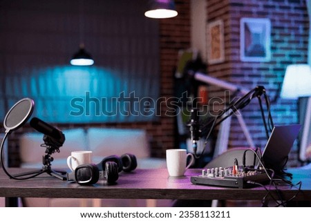 Empty home production studio with professional podcasting tools recording sound for streaming sites entertainment show. Live broadcasting from cozy location in living room decorated with purple lights