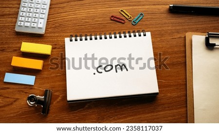 There is notebook with the word .com. It is as an eye-catching image.
