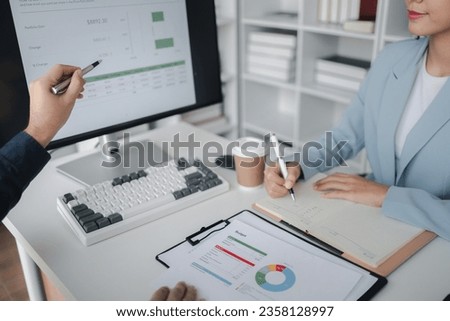 Two people looking at datasheets of marketing and sales results, analysis of business results jointly between executives, department heads and employees to brainstorm company sales management. Royalty-Free Stock Photo #2358128997