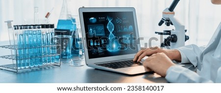 Scientist working on advance biotechnology computer software to study or analyze DNA data after making scientific breakthrough from chemical experiment on medical laboratory. Neoteric Royalty-Free Stock Photo #2358140017