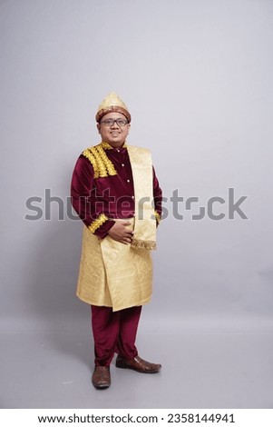 Southeast asian youth wearing Indonesian traditional clothes from Palembang, South Sumatra.By using songket fabric for its shawl and its vibrant color make it looks elegant It uses on ceremonial event Royalty-Free Stock Photo #2358144941