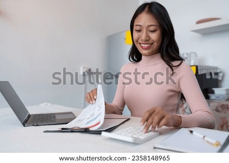 Asian business woman Calculate income with calculator, check document, financial report or profit. Income tax. Management concept. Accounting and Finance.