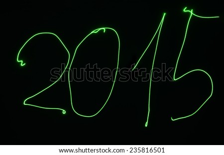 Light painting year 2015 on the wall by green laser light.