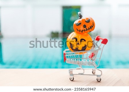 Halloween decoration item in shopping cart over blurred swimming pool background, outdoor day light, Halloween season sale