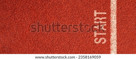 new beginnings concept. white starting line. word start on a running track in a stadium. top view Royalty-Free Stock Photo #2358169059
